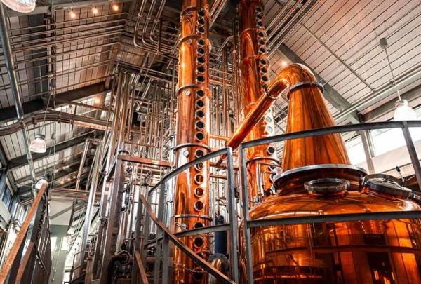 Interior of distillery with copper pot and column stills