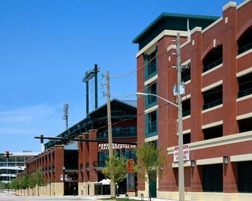 Exterior photo of Jacksonville Municipal Garages. Photo is a street view of the arena and sports parking garage. Red brick with green trim and accents.